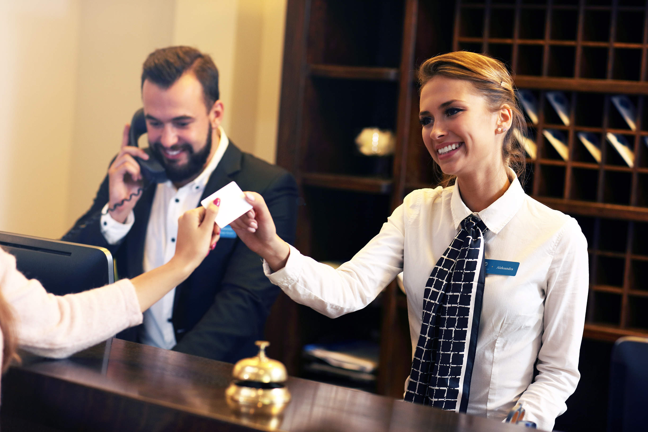 Guests getting key card in hotel - Business Phone Systems, Internet and ...