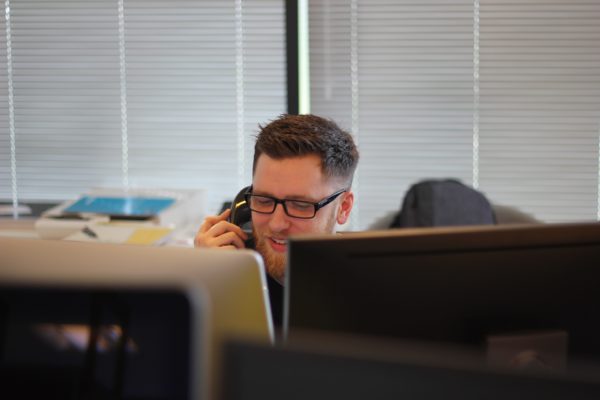 Man in office on phone call recording